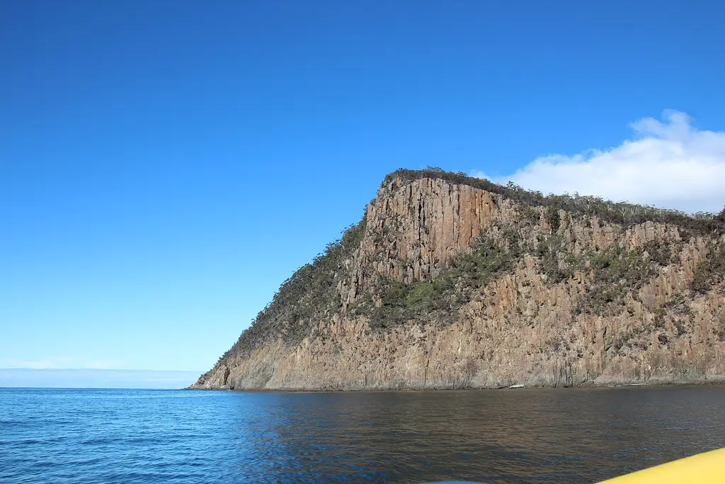 The dolerite cliffs of Fluted Cape seen from a wilderness cruise boat