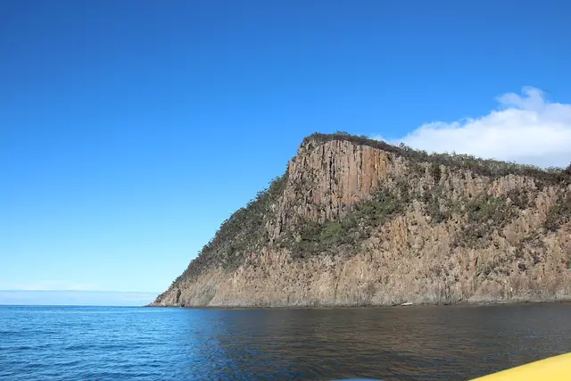 The dolerite cliffs of Fluted Cape seen from a wilderness cruise boat